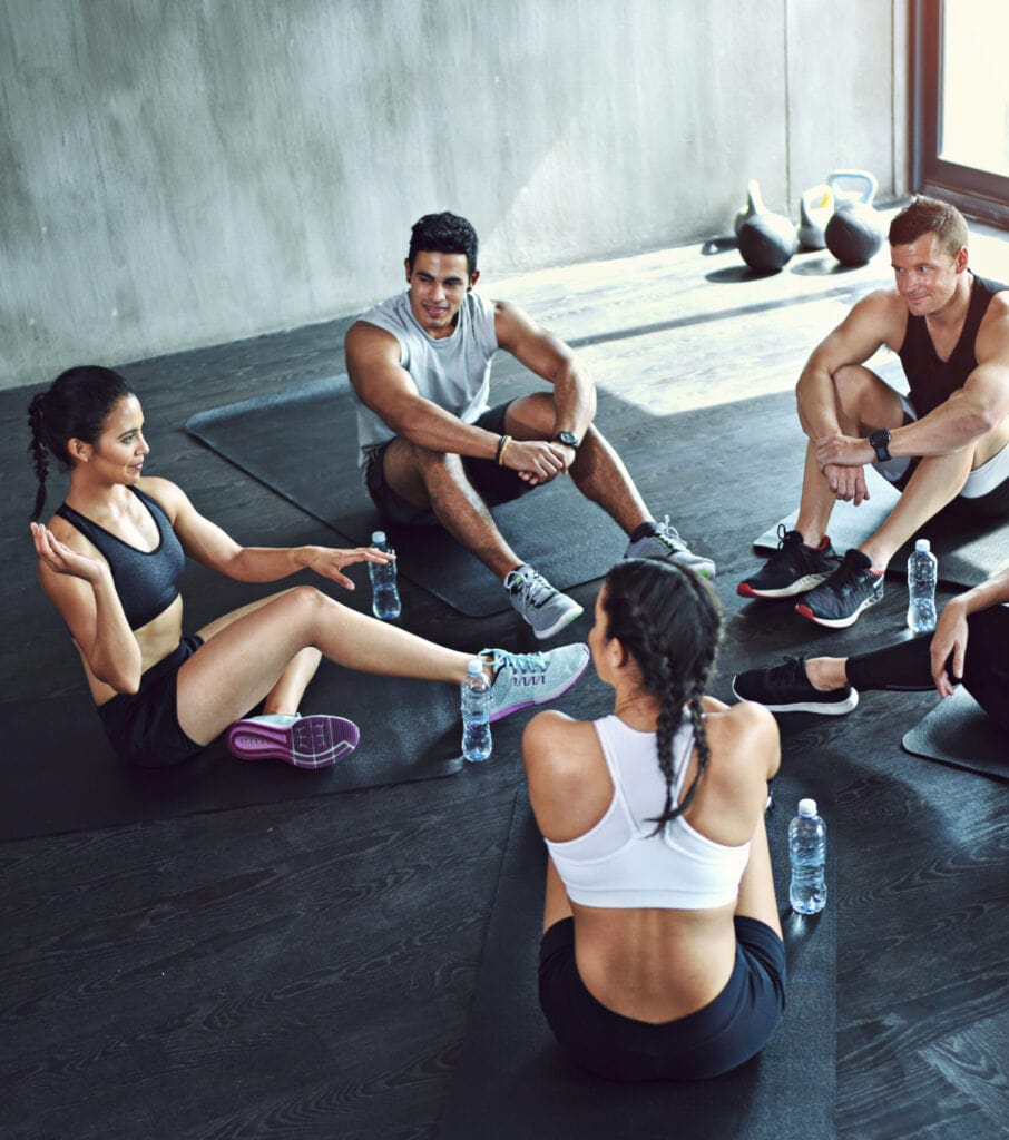 Shot of a group of gym buddies resting together after their workout
